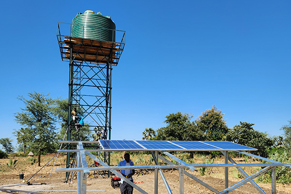 A water tower and solar panel installed by VAP.